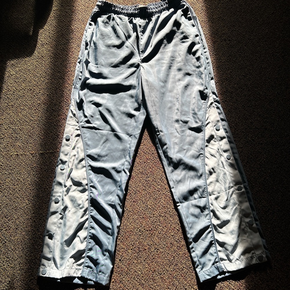 Two-tone blue Urban Outfitters windbreaker utility pants with tear-away buttons